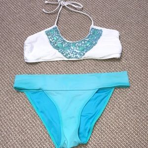 White bikini with blue jewel detail and blue btms